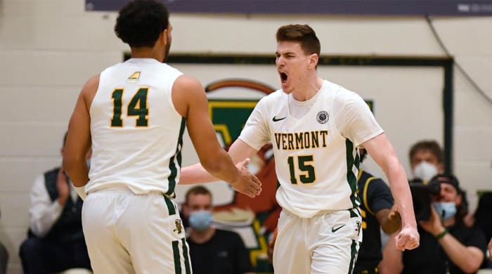 Vermont’s Finn Sullivan (15) reacts toward teammate Isaiah Powell (14)in the first half of an NCAA college basketball game for the America East Conference tournament championship, Saturday, March 12, 2022, in Burlington, Vt.